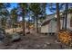 Spacious backyard with mature trees, storage shed, and woodpile perfect for nature lovers at 11848 Begole Cir, Golden, CO 80403