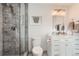 Modern bathroom with gray tiled shower, white vanity, and contemporary lighting at 11848 Begole Cir, Golden, CO 80403