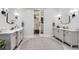 Bright bathroom featuring dual sinks, marble countertops, and walk-in closet, designed for comfort and style at 11848 Begole Cir, Golden, CO 80403