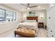 Light-filled bedroom with wood floors, ceiling fan, and a large window at 11848 Begole Cir, Golden, CO 80403