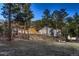 Charming home exterior featuring mature trees, outdoor lighting, and a hillside setting at 11848 Begole Cir, Golden, CO 80403