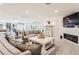Comfortable living room with a brick fireplace, plush seating, and bright lighting at 11848 Begole Cir, Golden, CO 80403