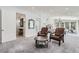 Spacious main bedroom with seating area, carpet, and ensuite access at 11848 Begole Cir, Golden, CO 80403