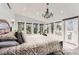 Bright and airy main bedroom with ensuite entry, large windows, and a chandelier at 11848 Begole Cir, Golden, CO 80403
