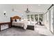 Well-lit main bedroom featuring plush carpet, ensuite access, and an elegant chandelier at 11848 Begole Cir, Golden, CO 80403