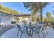 Outdoor patio featuring a dining table, chairs, and a scenic view of the forest and nearby mountains at 11848 Begole Cir, Golden, CO 80403