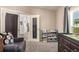 Bright Bedroom features a crib, changing table, carpet, and view into another room at 6105 Needlegrass # 307, Frederick, CO 80530