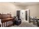 Bedroom with gray carpet, white doors, wood crib, and chair at 6105 Needlegrass # 307, Frederick, CO 80530