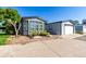 Home exterior with large windows, attached garage and low maintenance landscaping at 6105 Needlegrass # 307, Frederick, CO 80530