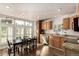 Kitchen and dining area featuring lots of windows, wood cabinets, and granite counters at 6105 Needlegrass # 307, Frederick, CO 80530