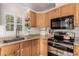 Close up of kitchen featuring stainless appliances, wood cabinets and granite countertops at 6105 Needlegrass # 307, Frederick, CO 80530