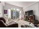 Cozy living room with a sliding glass door to the outside and comfortable brown couches at 6105 Needlegrass # 307, Frederick, CO 80530
