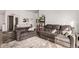 Open living room featuring comfortable couches, a soft area rug, and natural light at 6105 Needlegrass # 307, Frederick, CO 80530