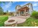 A well-maintained backyard with a patio, pergola, fire pit, and green lawn, perfect for outdoor living at 15767 E 109Th Ave, Commerce City, CO 80022