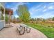 This home features a patio with pergola, picnic table, and a backyard with lush landscaping at 15767 E 109Th Ave, Commerce City, CO 80022