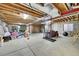 Unfinished basement with exposed ceiling beams and concrete walls, offering ample space for storage or customization at 15767 E 109Th Ave, Commerce City, CO 80022