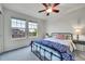 Bedroom with two windows providing natural light and a bed with stylish patterned bedding at 15767 E 109Th Ave, Commerce City, CO 80022