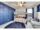 Bright bedroom with a bunk bed and a blue accent wall at 15767 E 109Th Ave, Commerce City, CO 80022