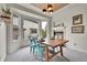 Bright dining room with corner windows, modern lighting, and stone fireplace at 15767 E 109Th Ave, Commerce City, CO 80022