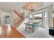 Dining room features an adjacent staircase, bay windows, and decorative ceiling at 15767 E 109Th Ave, Commerce City, CO 80022