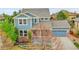 Attractive two-story home showcasing blue siding and stone accents complemented by a well-kept lawn at 15767 E 109Th Ave, Commerce City, CO 80022