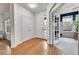 Bright entryway with hardwood floors and white walls, offering access to a home office at 15767 E 109Th Ave, Commerce City, CO 80022