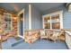 Charming porch detail showcases stone accents and a cozy seating area, enhancing the home's curb appeal at 15767 E 109Th Ave, Commerce City, CO 80022