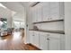 Hallway features custom cabinets and countertop, leading to dining area at 15767 E 109Th Ave, Commerce City, CO 80022