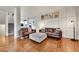 Cozy living room with wood floors, modern decor, and ample seating at 15767 E 109Th Ave, Commerce City, CO 80022