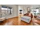 Bright living room features wood floors, large windows, and staircase access at 15767 E 109Th Ave, Commerce City, CO 80022