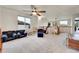 Loft area with carpet, ceiling fan, and windows at 15767 E 109Th Ave, Commerce City, CO 80022