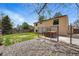 A backyard with a hot tub, a chain-link fence, and a rock garden at 12432 Bellaire St, Thornton, CO 80241