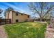 Large grassy backyard area with a wooden fence, and a hot tub at 12432 Bellaire St, Thornton, CO 80241