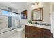 Well-lit bathroom showcasing a modern vanity, marble countertops, and a glass-enclosed shower at 12432 Bellaire St, Thornton, CO 80241