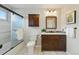 Chic bathroom featuring a stylish vanity, modern fixtures, and a glass-enclosed shower at 12432 Bellaire St, Thornton, CO 80241