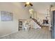 Open-concept dining area featuring tile floors and natural light at 12432 Bellaire St, Thornton, CO 80241