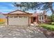 Charming home featuring a well-manicured lawn, front porch, and attached two-car garage at 12432 Bellaire St, Thornton, CO 80241