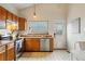 Functional kitchen space with stainless steel appliances and tile flooring at 12432 Bellaire St, Thornton, CO 80241