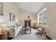 Inviting living room showcasing a fireplace, plush seating, and soaring ceilings at 12432 Bellaire St, Thornton, CO 80241