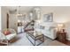 Bright, open living room with modern decor and staircase access at 12432 Bellaire St, Thornton, CO 80241