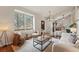 Cozy living room with bright natural light, hardwood floors, and stylish furnishings at 12432 Bellaire St, Thornton, CO 80241