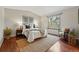 Serene main bedroom with a large window, modern decor, and hardwood floors at 12432 Bellaire St, Thornton, CO 80241