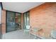 Outdoor balcony featuring two chairs, a table, and sliding glass doors to the unit's interior at 1551 Larimer St # 1106, Denver, CO 80202