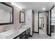 Contemporary bathroom with double sinks, modern lighting, and a door to the walk-in closet at 1551 Larimer St # 1106, Denver, CO 80202