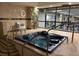 Indoor hot tub with tile surround and view of the fitness center at 1551 Larimer St # 1106, Denver, CO 80202
