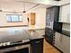 Modern kitchen view of a modern open floor plan with an island cooktop and a living room at 1551 Larimer St # 1106, Denver, CO 80202