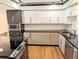 Contemporary kitchen with granite countertops, stainless steel appliances, and ample cabinet space at 1551 Larimer St # 1106, Denver, CO 80202