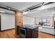 Spacious kitchen island and oven cooktop with modern lighting fixture and open living space concept at 1551 Larimer St # 1106, Denver, CO 80202