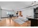 Open living room with hardwood floors, white sectional sofa, and adjacent dining area at 1551 Larimer St # 1106, Denver, CO 80202