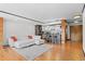 Stylish living room with sleek white sectional sofa, wood floors, and a view of modern open kitchen at 1551 Larimer St # 1106, Denver, CO 80202